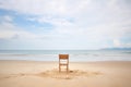 a deserted sandy beach with an empty chair