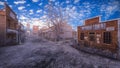 Deserted street in an old wild western town with wooden buildings. 3D rendering Royalty Free Stock Photo