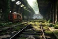 deserted train station platform with rusty tracks and overgrowth Royalty Free Stock Photo