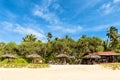 Deserted tropical beach with umbrellas Royalty Free Stock Photo