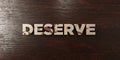 Deserve - grungy wooden headline on Maple - 3D rendered royalty free stock image