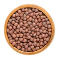 Desi chickpeas in wooden bowl over white Royalty Free Stock Photo