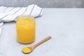 Desi ghee or clarified butter in a jar and wooden spoon Royalty Free Stock Photo
