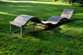 Design bench in the shape of a wavy line. wooden paneling on a metal galvanized frame. The bench is atypical to order in a city pa