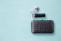 Design black shiny leather purse with lipstick stick and a bottle of perfume Royalty Free Stock Photo