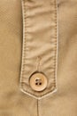 Design botton of brown shirt on fabric textile Royalty Free Stock Photo