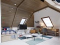 The design of the children`s room for the teenager on the attic is in the loft style, the ceiling is hemmed with wood and the Royalty Free Stock Photo