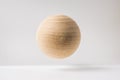 Abstract real wooden sphere with surreal layout on white surface background