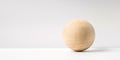 Abstract real wooden sphere with surreal layout on white surface background