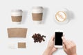 Design concept of mockup using smartphone and coffee set isolated on white background. Copy space for text and logo. Royalty Free Stock Photo