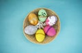 Design Easter egg collections in round rattan basket Royalty Free Stock Photo