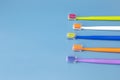 Design Flat Lay Multicolor Toothbrushes on Blue Background, Copy Space. Oral Hygiene