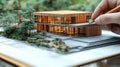 Design framework in focus - house model positioned over detailed blueprints, emphasizing architectural structure