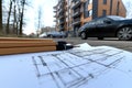 Design framework in focus - house model positioned over detailed blueprints, emphasizing architectural structure