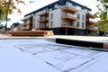 Design framework in focus - house model positioned over detailed blueprints, emphasizing architectural structure