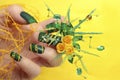 Design green acrylic nails with yellow roses .