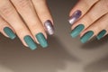 The design of the manicure is green with silver.
