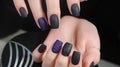 Design of manicure matt black and blue nails