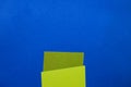 Design paper, shades of green, on a blue table with a dark background Royalty Free Stock Photo