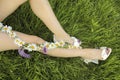 The design of a pedicure with a matte lilac coating on a girl sitting on the green grass Royalty Free Stock Photo