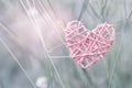 Design pink wooden heart over blurred grass background with vintage light Royalty Free Stock Photo