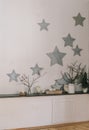 The design of the wall, the interior. Star. Dry branches. Candles Royalty Free Stock Photo