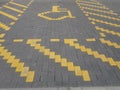 A designated handicap parking space outline in yellow brickwork Royalty Free Stock Photo