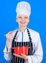 Designed for culinary enthusiasts. Happy cook holding pot and work tool. Professional chef smiling with cooker and Royalty Free Stock Photo