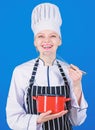 Designed for culinary enthusiasts. Happy cook holding pot and work tool. Professional chef smiling with cooker and Royalty Free Stock Photo