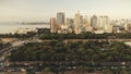 Designed park landscape aerial. Modern skyscrapers above green tropic plants and trees