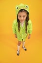 Designed to go to school. Little school girl wearing cute raincoat on yellow background. Small child back to school in