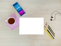 Designer, artist workplace. Creative, trendy, artistic mock up with white paper, cup of coffee, earphones, a yellow pencil,crayons