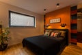 Designer bedroom with orange wall Royalty Free Stock Photo