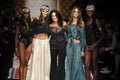 Designer Christina Ferrari (C) and models pose on the runway during the Fisico show