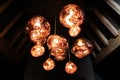 Copper colored glass light installation in attic with wooden beams
