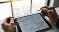 Designer creating user interface wireframes on a tablet with a stylus for app development Royalty Free Stock Photo