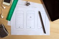 Designer desk with paper prototype of a mobile application