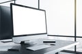 Designer desktop with blank white computer screen