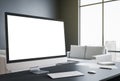 Designer desktop with blank white computer screen