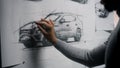 Designer drawing new car sketch with marker Royalty Free Stock Photo