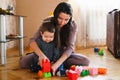 Designer games mom and baby. Baby Boy And Mother Playing Together With Construction Set Toy Royalty Free Stock Photo