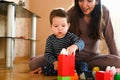 Designer games mom and baby. Baby Boy And Mother Playing Together With Construction Set Toy Royalty Free Stock Photo