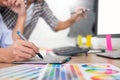 Designer graphic creative creativity working together coloring using graphics tablet and a stylus at desk with colleague Royalty Free Stock Photo