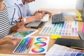 Designer graphic creative creativity working together coloring using graphics tablet and a stylus at desk with colleague Royalty Free Stock Photo