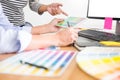 Designer graphic creative creativity working together coloring using graphics tablet and a stylus at desk with colleague Royalty Free Stock Photo