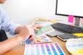 Designer graphic creative creativity working together coloring using graphics tablet and a stylus at desk with colleague Royalty Free Stock Photo