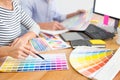 Designer graphic creative creativity working together coloring using graphics tablet and a stylus at desk with colleague Royalty Free Stock Photo