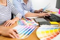 Designer graphic creative creativity working together coloring using graphics tablet and a stylus at desk with colleague Royalty Free Stock Photo