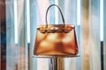 designer handbag showcased on pedestal stand