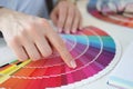 Designer holding color swatch at desk in office closeup Royalty Free Stock Photo